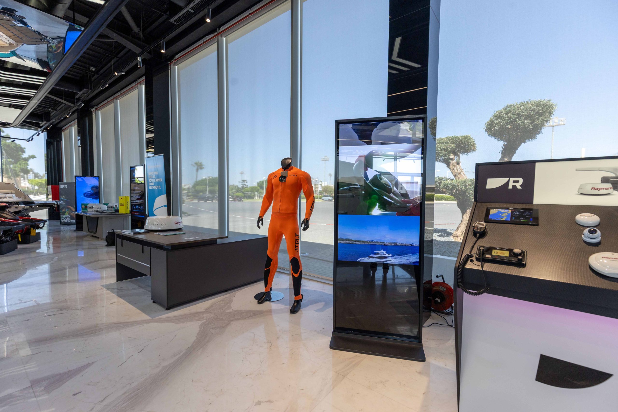 Watersports and jet-ski equipment display beside the marine electronics wall