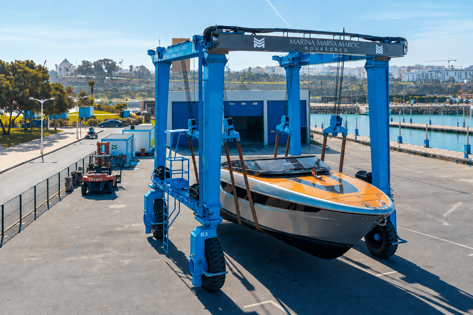 The blue Marina Marsa Maroc travel lift handling a yacht at Bouregreg marina