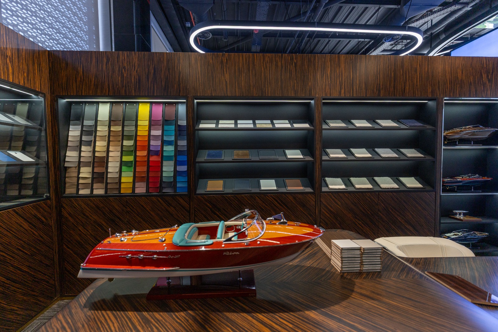 A Riva model on the timber consultation table, with colourful material samples behind it