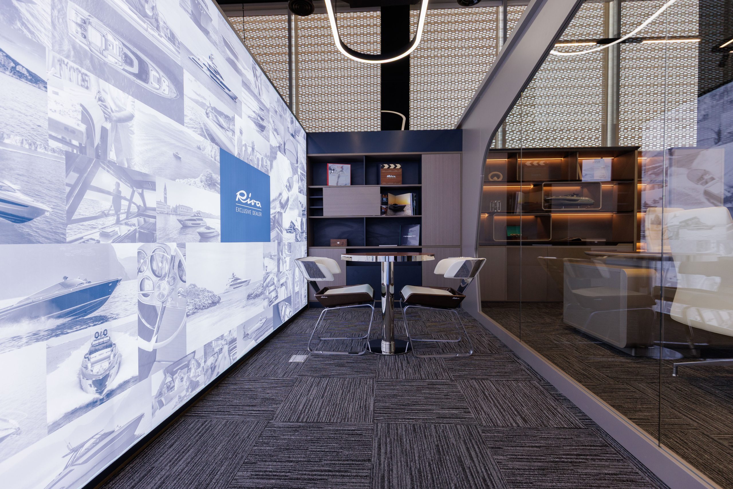 A private consultation lounge surrounded by yacht photography and model displays