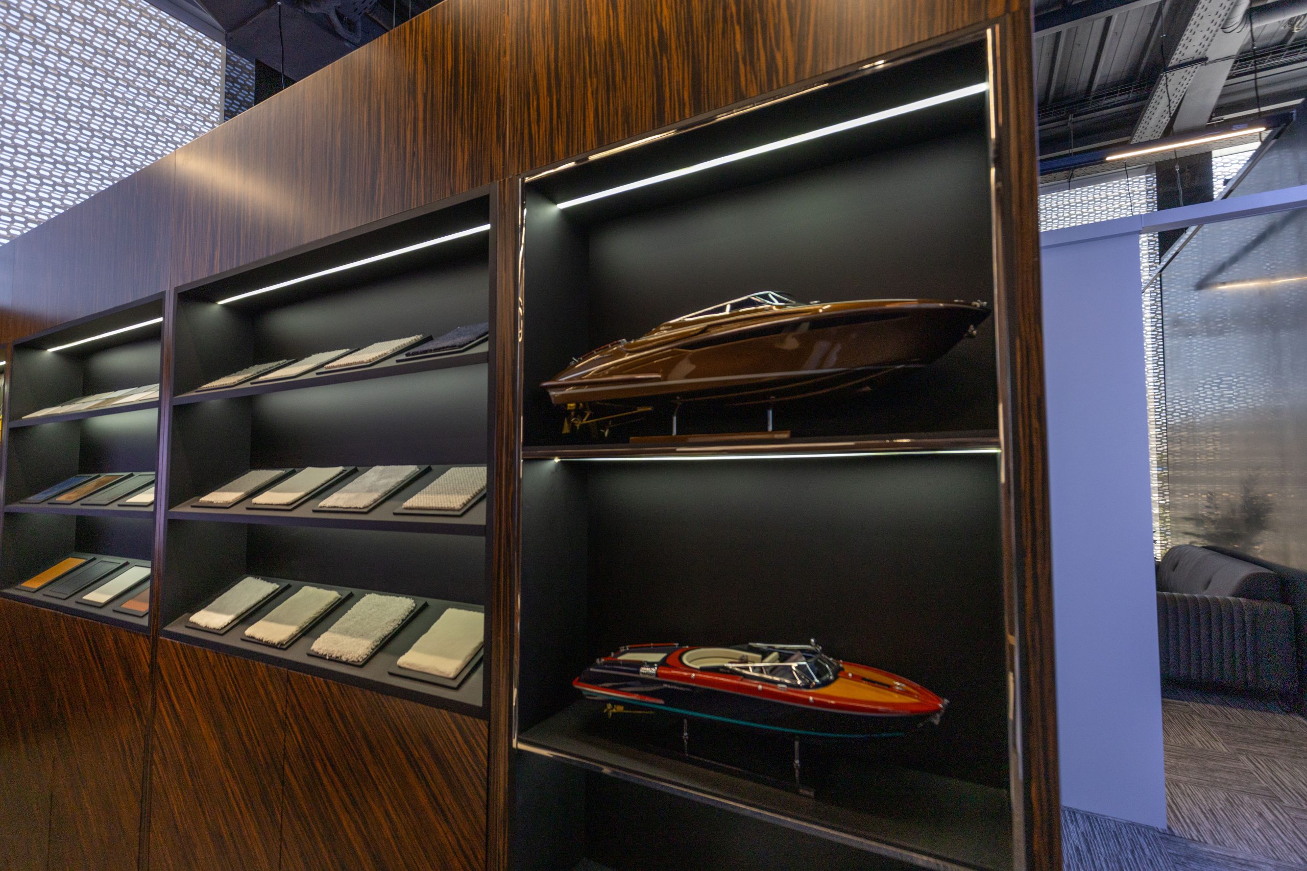 Riva yacht models beside shelves of fabric and finish samples