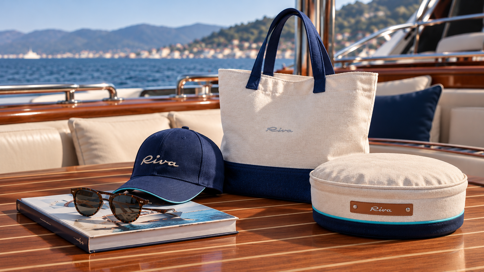 Riva accessories on a polished yacht table, with a canvas bag, navy cap, sunglasses and cushion